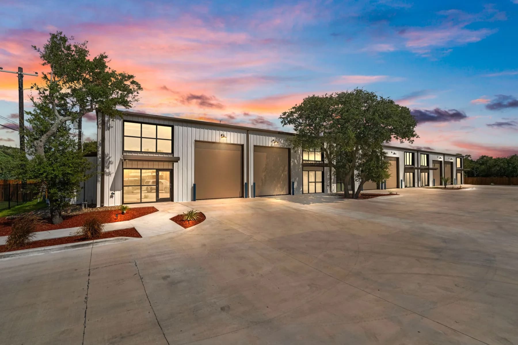 SIDE BY SIDE® Coastal Base Camps at dusk with garage lights on