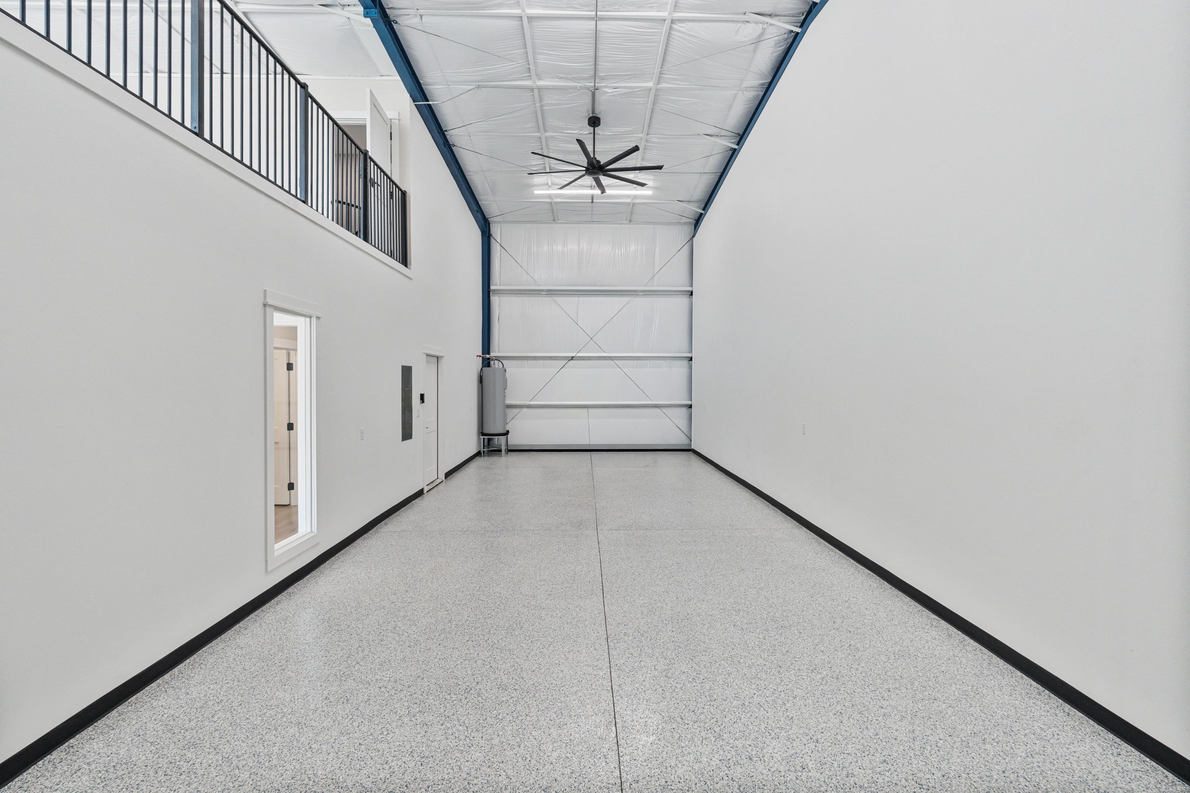 The empty 40-foot garage, looking down its full length to the door