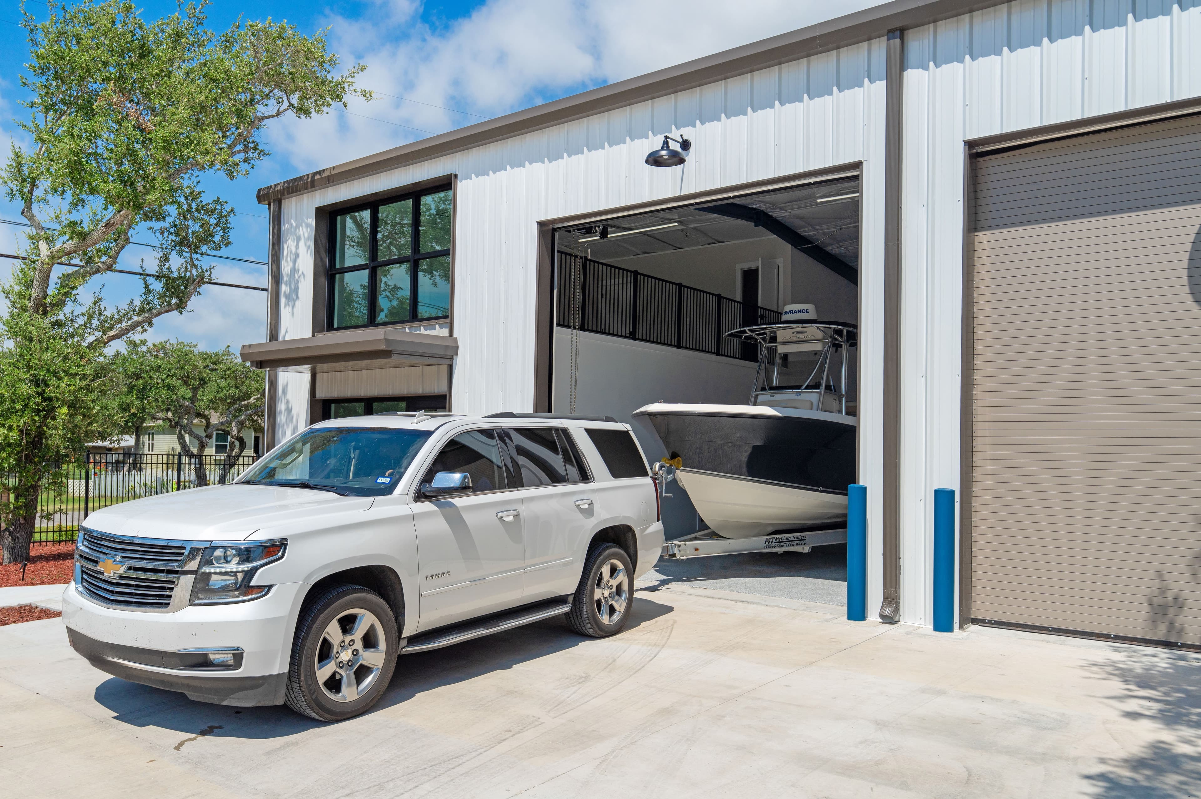 An SUV backing a boat into a 40-foot SIDE BY SIDE® garage
