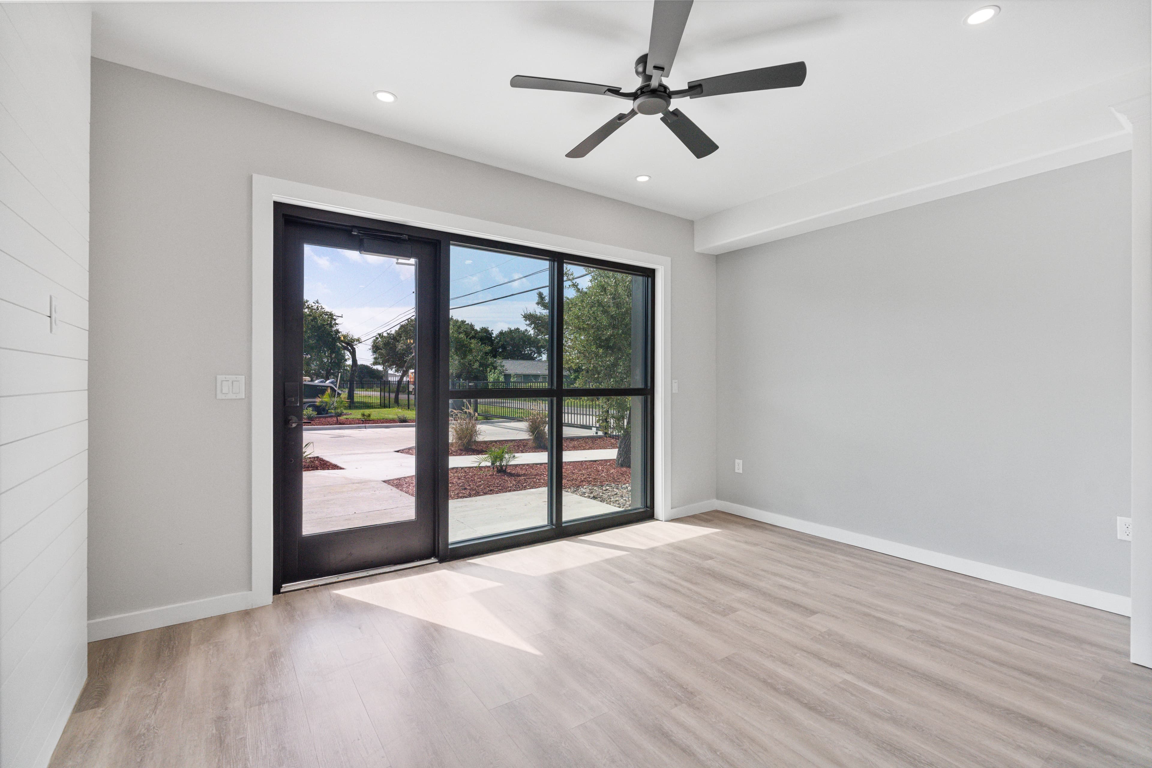 Living area with a black-framed sliding glass door