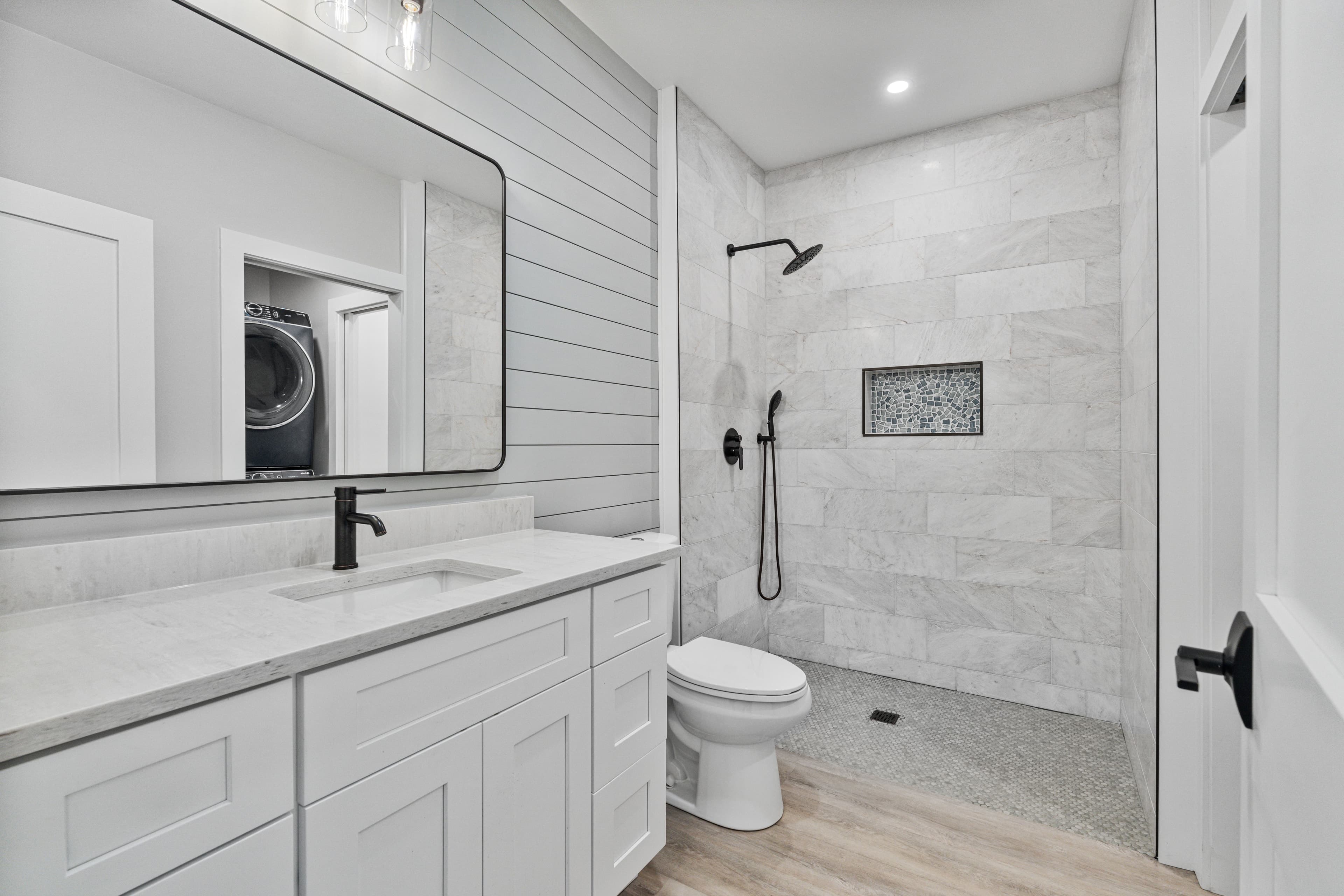 Suite bath: vanity, mirror and tiled walk-in shower